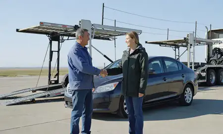 Vehicle owner beside their delivered car in North Dakota, United States
