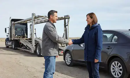 Vehicle owner beside their delivered car in Belcourt, North Dakota, United States