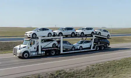 Multi-level car carrier on the highway to Beulah, North Dakota, United States