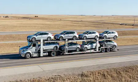 Multi-level car carrier on the highway to Bottineau, North Dakota, United States