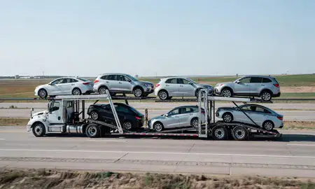 Multi-level car carrier on the highway to Carrington, North Dakota, United States