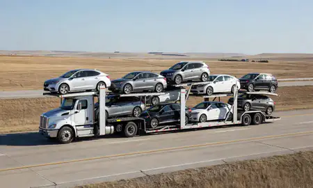Multi-level car carrier on the highway to Dickinson, North Dakota, United States