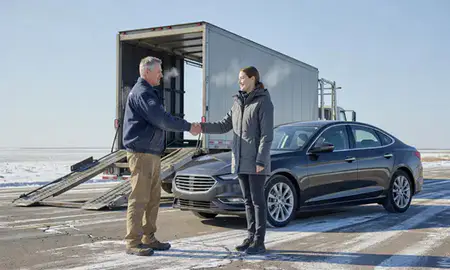 Vehicle owner beside their delivered car in Fargo, North Dakota, United States