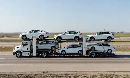 Multi-level car carrier on the highway to Grafton, North Dakota, United States