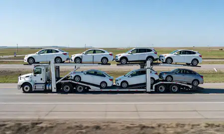 Multi-level car carrier on the highway to Grand Forks, North Dakota, United States