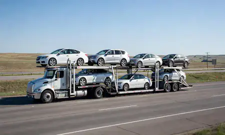 Multi-level car carrier on the highway to Hazen, North Dakota, United States
