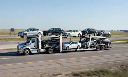 Multi-level car carrier on the highway to Horace, North Dakota, United States