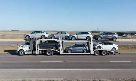 Multi-level car carrier on the highway to Lincoln, North Dakota, United States