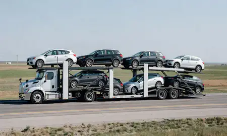 Multi-level car carrier on the highway to Lisbon, North Dakota, United States
