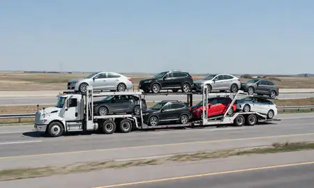 Multi-level car carrier on the highway to Mayville, North Dakota, United States