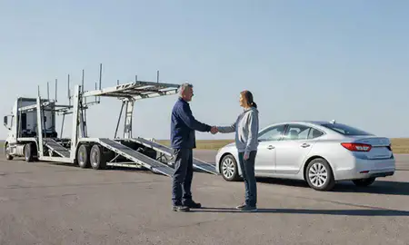 Vehicle owner beside their delivered car in Minot, North Dakota, United States
