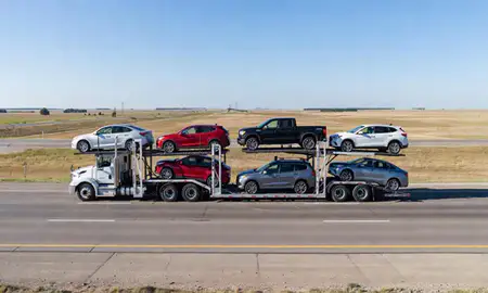 Multi-level car carrier on the highway to Oakes, North Dakota, United States