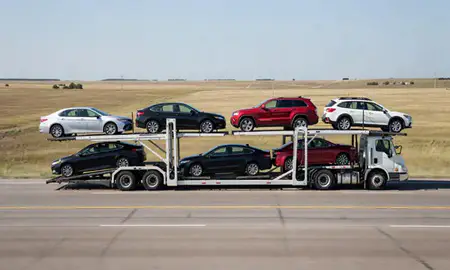 Multi-level car carrier on the highway to Rugby, North Dakota, United States
