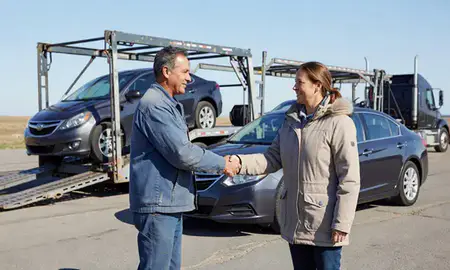 Vehicle owner beside their delivered car in Stanley, North Dakota, United States