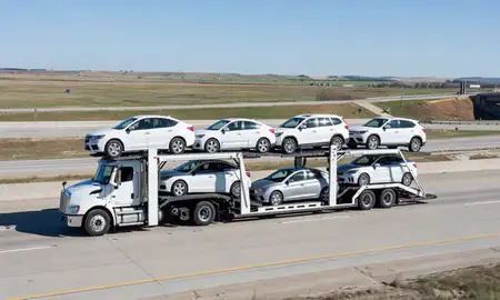 Multi-level car carrier on the highway to Valley City, North Dakota, United States