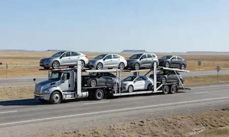 Multi-level car carrier on the highway to Watford City, North Dakota, United States