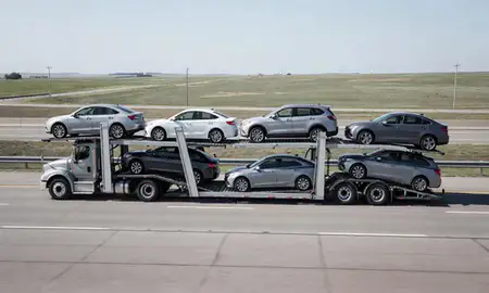 Multi-level car carrier on the highway to Williston, North Dakota, United States