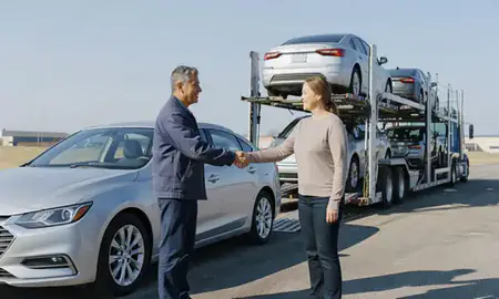 Vehicle owner beside their delivered car in Ohio, United States
