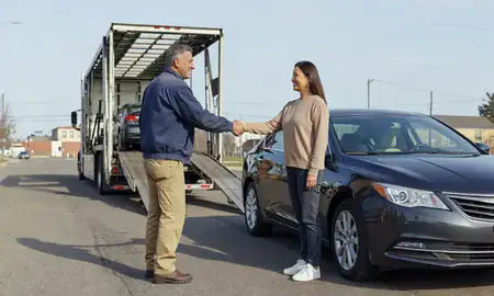 Vehicle owner beside their delivered car in Canton, Ohio, United States