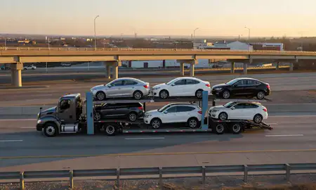 Car transporter with the Elyria, Ohio, United States skyline behind it