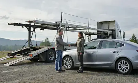 Vehicle owner beside their delivered car in Oregon, United States