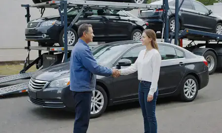 Vehicle owner beside their delivered car in Beaverton, Oregon, United States