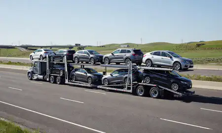 Multi-level car carrier on the highway to Hayesville, Oregon, United States