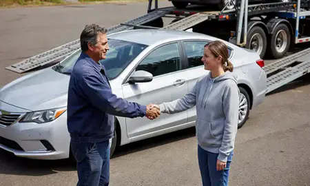 Vehicle owner beside their delivered car in Hayesville, Oregon, United States