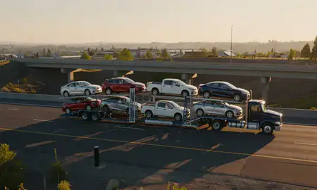 Car transporter with the Klamath Falls, Oregon, United States skyline behind it