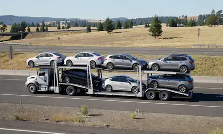 Multi-level car carrier on the highway to Medford, Oregon, United States