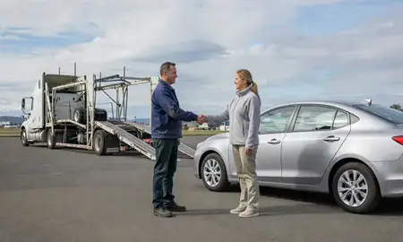 Vehicle owner beside their delivered car in Oregon City, Oregon, United States