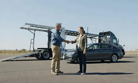 Vehicle owner beside their delivered car in Redmond, Oregon, United States