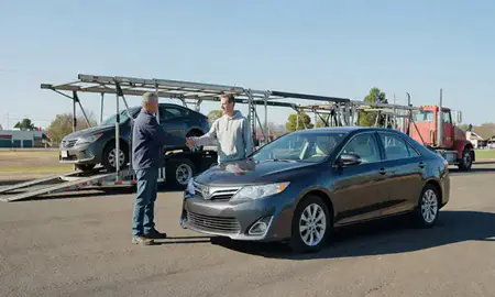 Vehicle owner beside their delivered car in Springfield, Oregon, United States