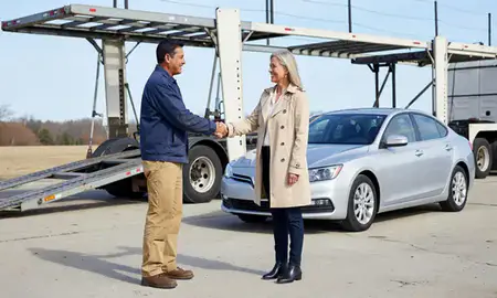 Vehicle owner beside their delivered car in Chester, Pennsylvania, United States