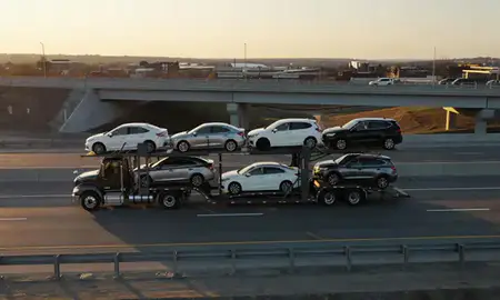 Car transporter with the Hazleton, Pennsylvania, United States skyline behind it