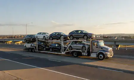Car transporter with the Lebanon, Pennsylvania, United States skyline behind it