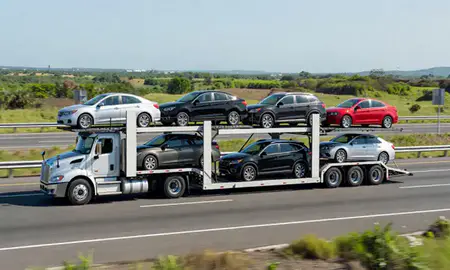 Multi-level car carrier on the highway to Arecibo, Puerto Rico, United States