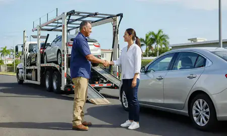 Vehicle owner beside their delivered car in Candelaria, Puerto Rico, United States