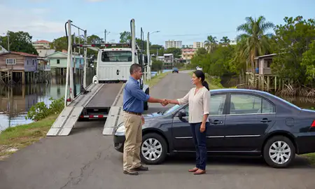 Vehicle owner beside their delivered car in Caño Martin Peña, Puerto Rico, United States
