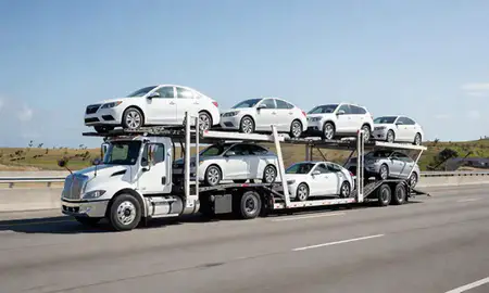 Multi-level car carrier on the highway to Hormigueros, Puerto Rico, United States