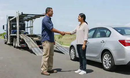 Vehicle owner beside their delivered car in Juana Díaz, Puerto Rico, United States