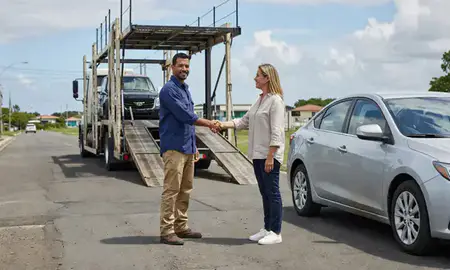 Vehicle owner beside their delivered car in Río Grande, Puerto Rico, United States