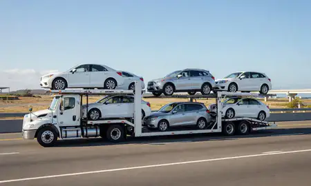 Multi-level car carrier on the highway to San Juan, Puerto Rico, United States