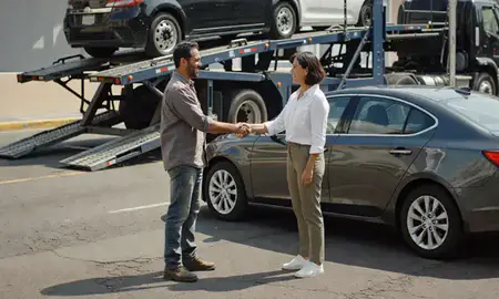 Vehicle owner beside their delivered car in San Juan, Puerto Rico, United States