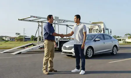 Vehicle owner beside their delivered car in Trujillo Alto, Puerto Rico, United States