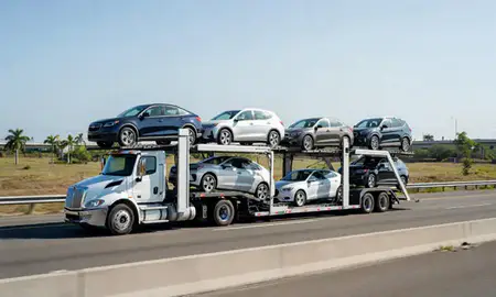 Multi-level car carrier on the highway to Vega Baja, Puerto Rico, United States