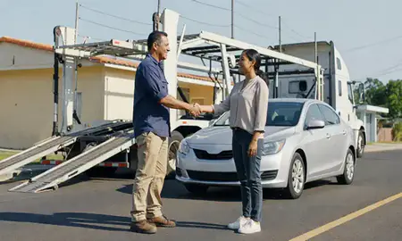 Vehicle owner beside their delivered car in Vega Baja, Puerto Rico, United States