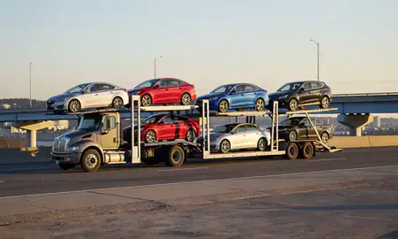 Car transporter with the Rhode Island, United States skyline behind it