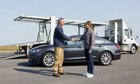 Vehicle owner beside their delivered car in Ashaway, Rhode Island, United States