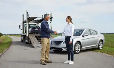 Vehicle owner beside their delivered car in Carolina, Rhode Island, United States